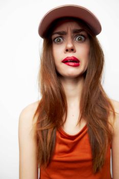 Portrait of a woman in a cap With a surprised look, his face grimaces fashionable
