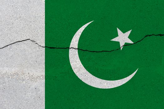 Pakistan flag on concrete wall with crack