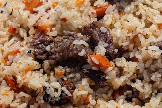 Traditional Eastern culinary dish - pilaf. Ingredients: rice with slices of meat