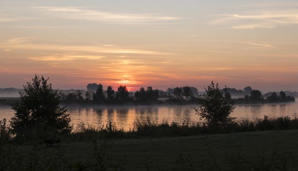 sunrise over the river maas in Holland