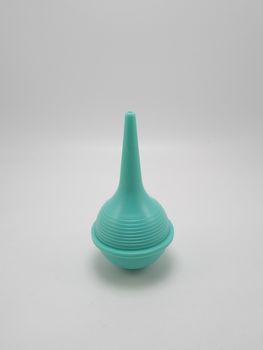 Green baby nasal aspirator or snot sucker use to suck out mucus booger