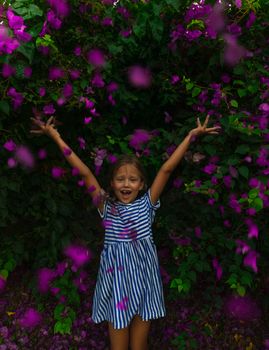Happy Little Girl Throws Flowers