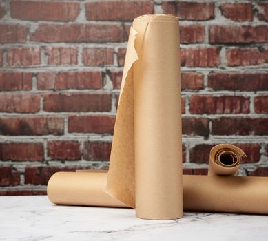 rolls of brown parchment paper on a white table