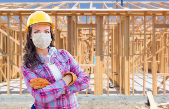 Female Contractor In Hard Hat Wearing Medical Face Mask During C