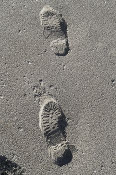 Footprints of shoes on a sandy beach