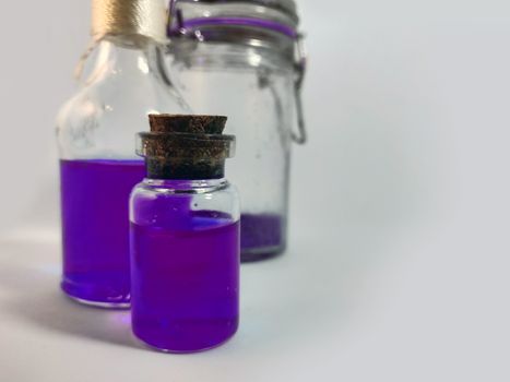 Potions with violet liquid. Alchemy set with flasks. small glass bottles with colored liquid for game role play. magic potions with cork stopper for larp. bottle and potion. color flask hd.