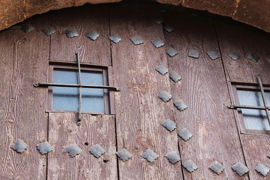 Old wooden door with wrought iron details