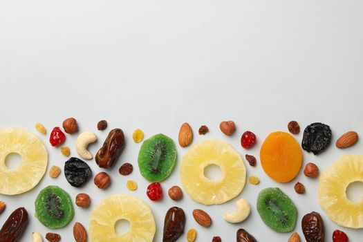 Nuts and dried fruits on gray background, top view