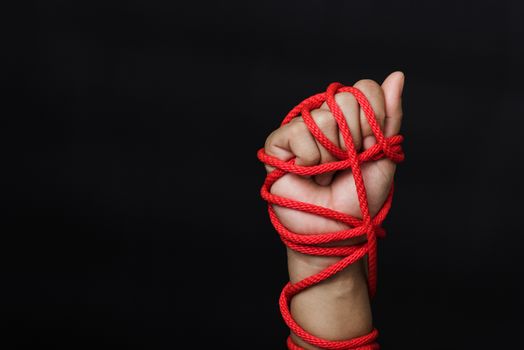 Woman hand tied up with rope