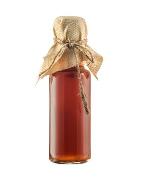 Glass bottle with syrup isolated on a white background