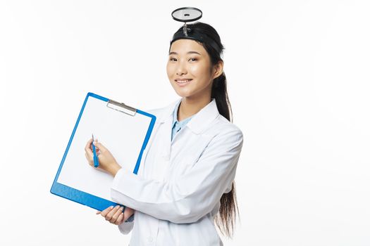 Woman doctor in a medical gown documents in hand and examining instrument