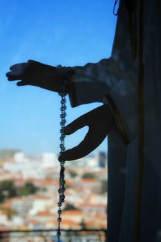 Virgin Mary hands holding a rosary 