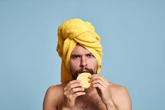 a man with a yellow towel on his head bum bare shoulders clean skin taking a shower