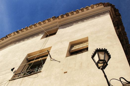 Old facade and streetlight in a village in Castilla La Mancha, Spainh