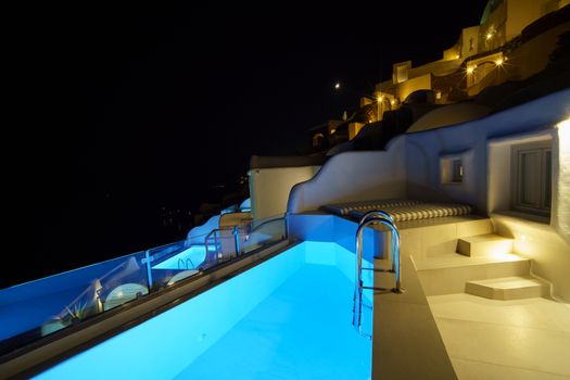 The pool side at night in the romantic village, White hotel at O