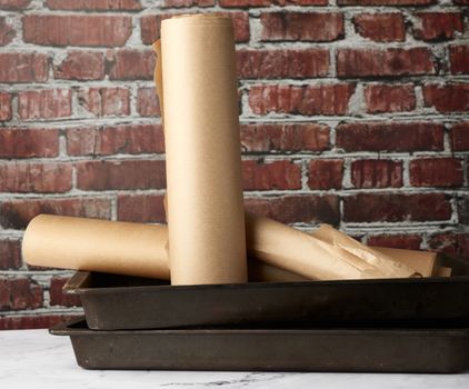 rolls of brown parchment paper on a white table
