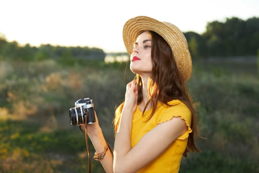 Pretty woman straightens her hair camera hat fresh air leisure lifestyle. High quality photo