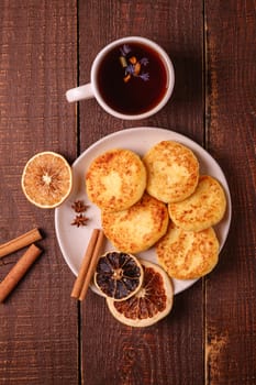 Cottage cheese fritters with hot black aromatic tea, Christmas