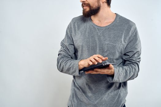 Man with tablet in hands technology internet lifestyle confident cropped view