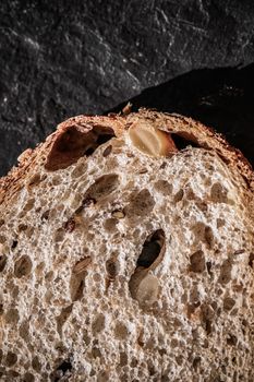 Fresh whole grain seeded bread, organic wheat flour, closeup sli