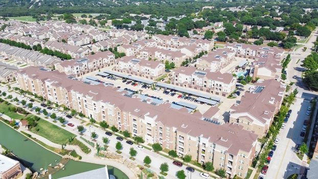 Flyover multistory apartment complex and suburban residential area in Flower Mound, Texas, US