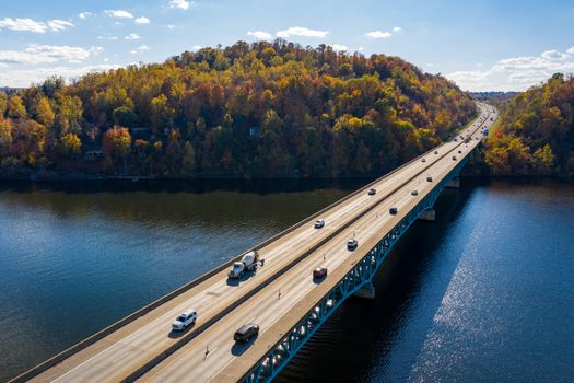 Traffic on the interstate through fall colors on Cheat Lake Morgantown, WV with I68 bridge