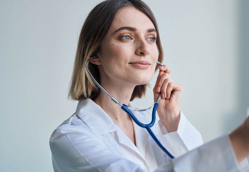 Doctor medical gown nurse stethoscope health light background