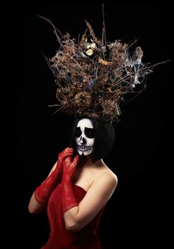  woman of Caucasian appearance with skeleton make-up stands in a