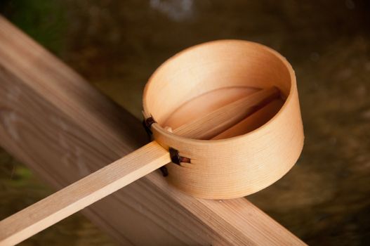 Wooden dipper of holy zen water in Japan Shinto temple