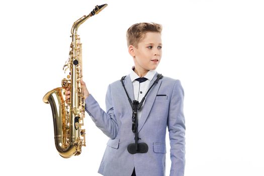 Boy musician playing saxophone performing jazz
