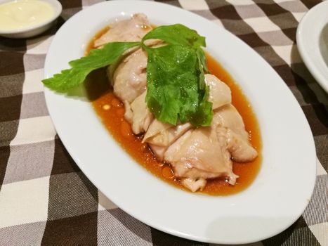 Juicy Singaporean Hainanese chicken rice  on sesame oil sauce