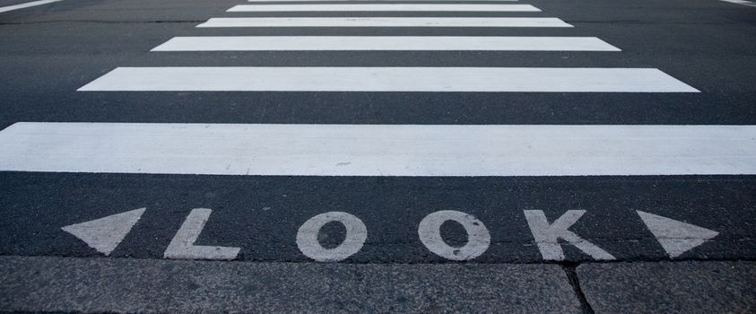 Look text with zebra crossing path on a road