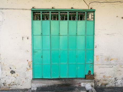 Green metal collapsable vintage door in Penang Malaysia