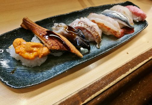Sea urchin roe and unagi grilled sea fish sushi served fresh