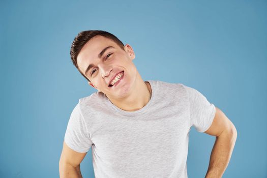 Emotional man in white t-shirt cropped view on blue background lifestyle
