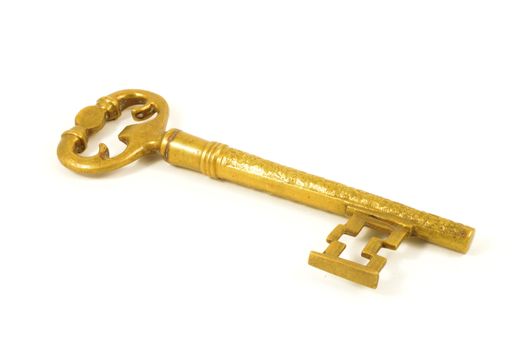 An isolated over white image of a large brass key.