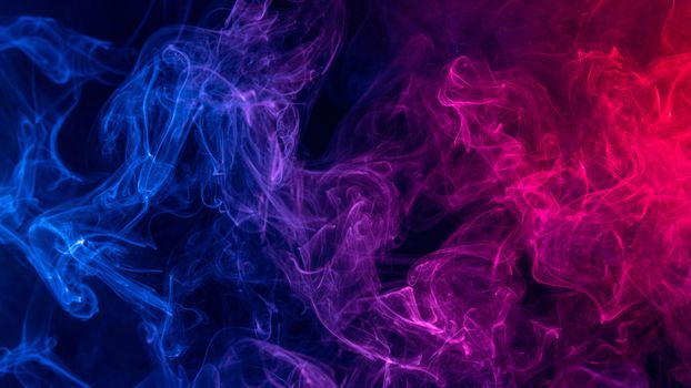 Conceptual image of colorful red and blue color smoke on dark bl