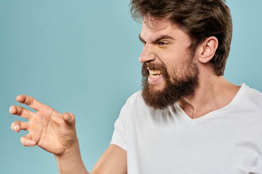 Bearded man emotions facial expression gestures hands close-up blue background