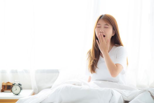 Beautiful of portrait young asian woman yawn sitting with sleep 