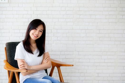 Portrait of beautiful young asian woman happiness sitting on cha
