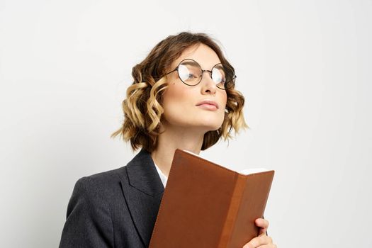 business woman in a suit with documents in hands light background curly hair hairstyle