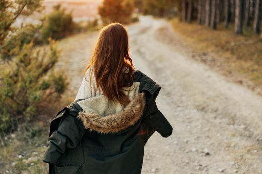 woman in warm jacket travel walk back view. High quality photo