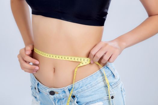 Closeup asian woman diet and slim with measuring waist for weigh