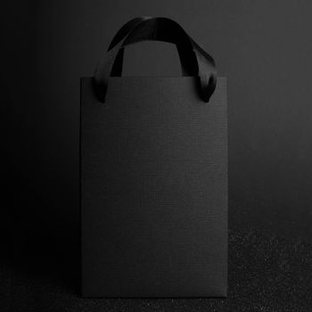 Black Friday blank empty paper bag with copy space for text and logo on dark background sale concept