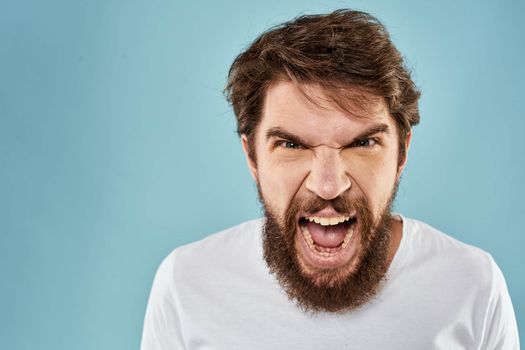 Bearded man emotions facial expression gestures hands close-up blue background