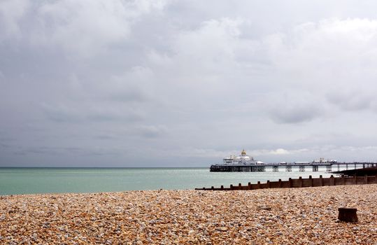 View across pebble beach to Eastbourne pier on the English coast