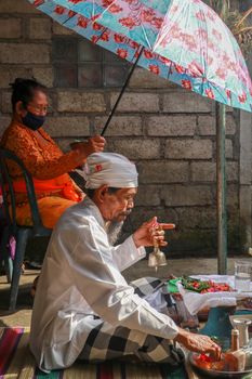 alinese Brahman performing morning rituals in the Bali temple, Indonesia