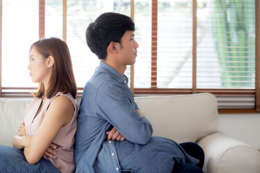Relationship of young asian couple having problem on sofa in the