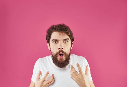 Man on a pink background surprise irritability emotions and stress