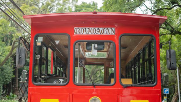 Front Side of a Red and Yellow Trolley Car on the Streets of Coyoacan